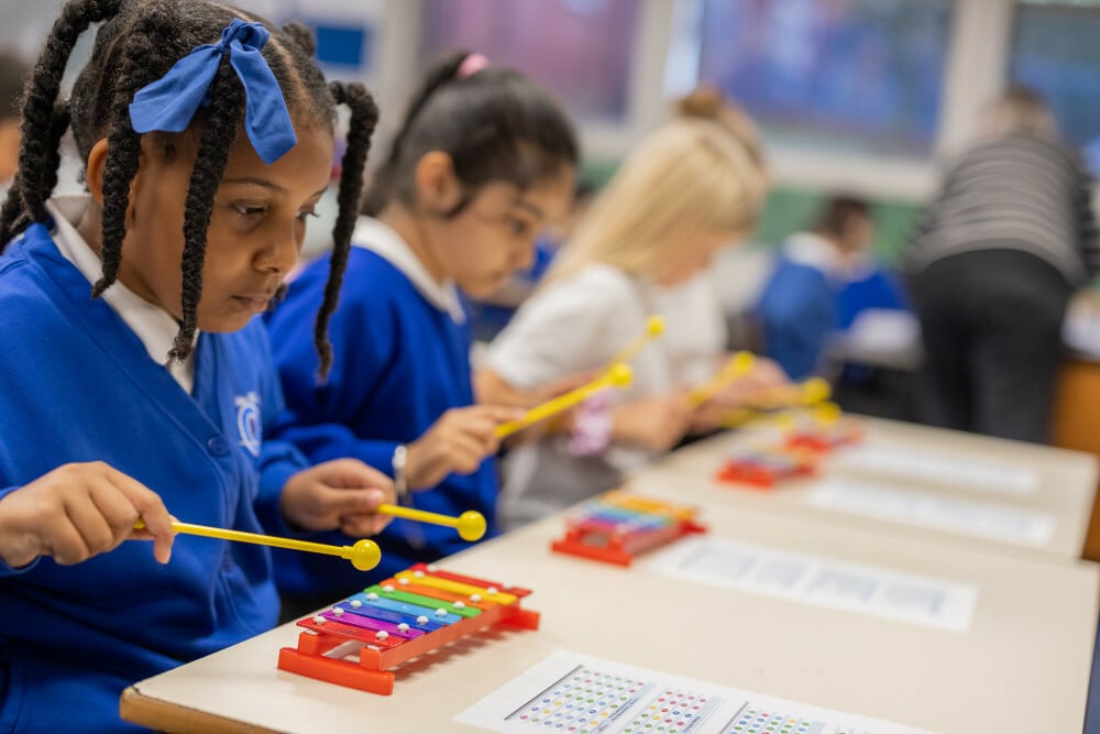 primary school pupils in music lesson