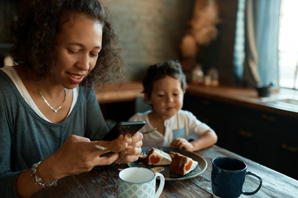 parent on phone in a cafe